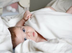 baby in cot bed michal-bar-haim-NYvRaxVZ-_M-unsplash.jpg